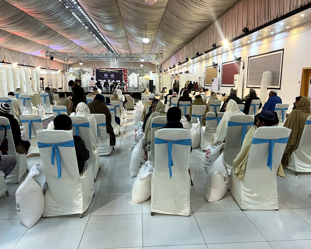 A distribution hall with a ration sack placed beside every seat
